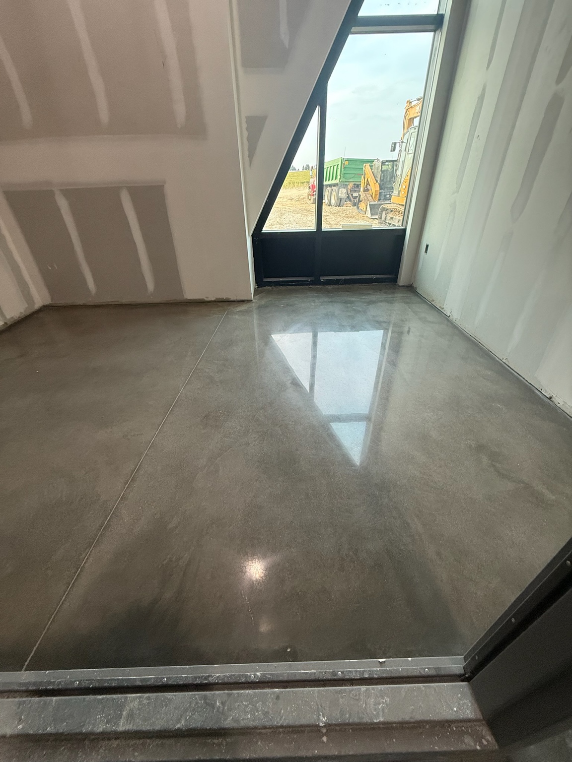 Polished concrete floor reflecting light in a newly built Iowa commercial space