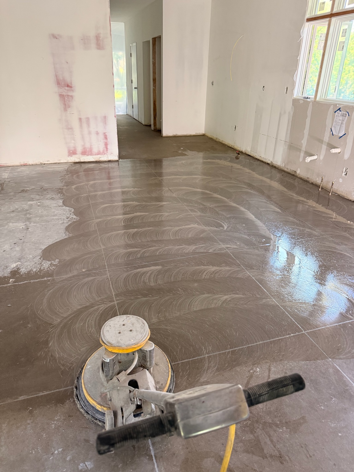Floor polishing machine working across an interior concrete floor in Waterloo