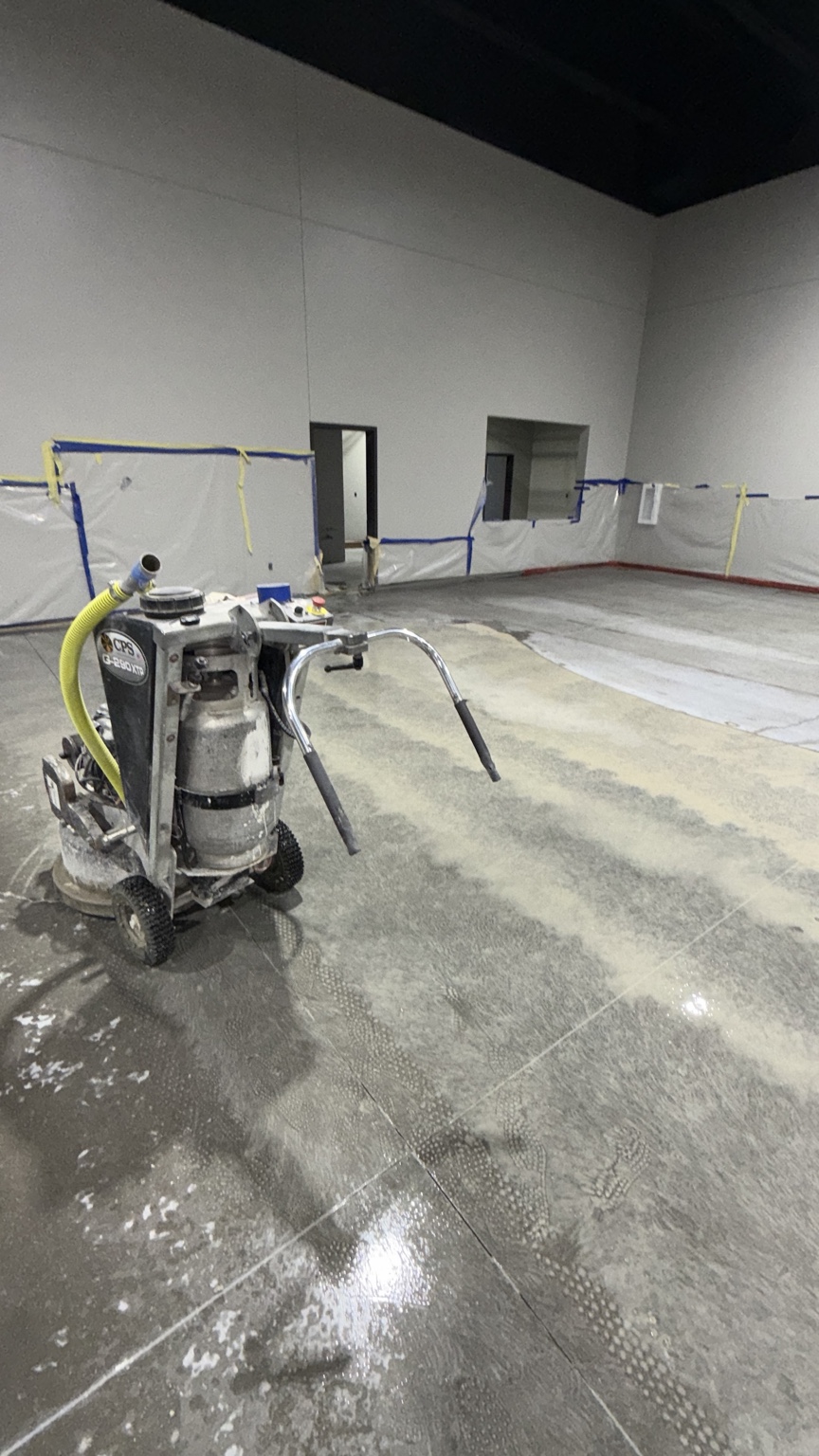 Industrial floor grinder on a commercial concrete floor during preparation in Des Moines