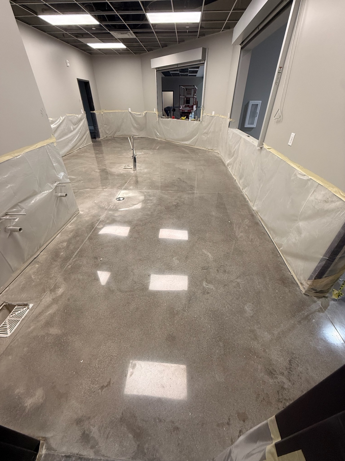Polished concrete floor reflecting overhead lights in a Des Moines commercial room